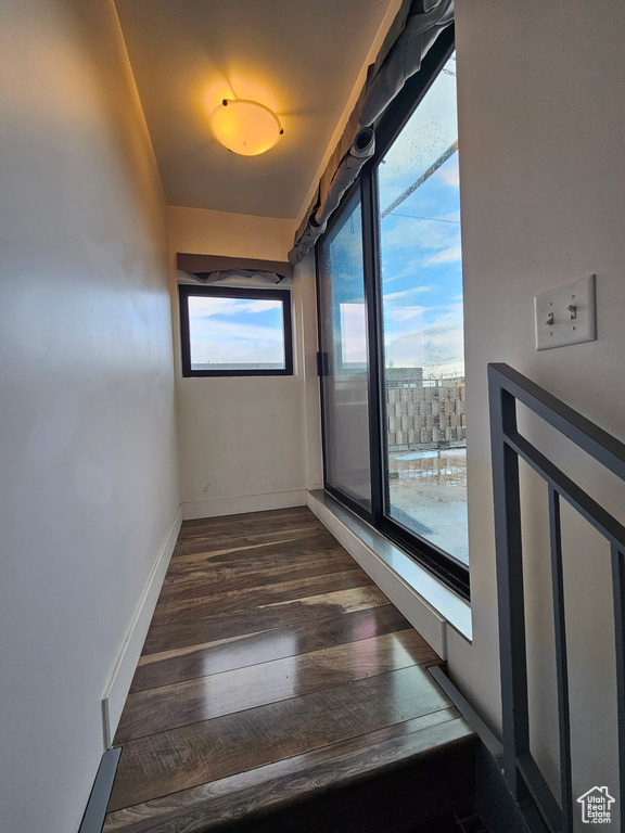 Empty room featuring dark hardwood / wood-style floors