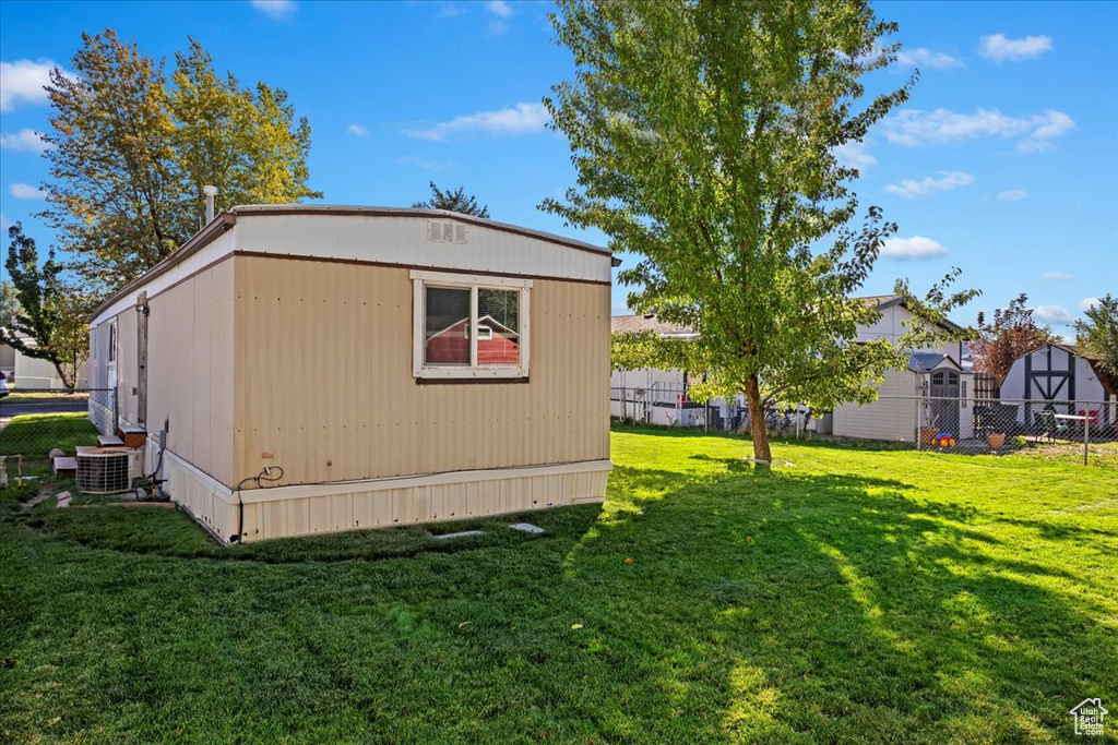 Exterior space with a yard and central AC unit