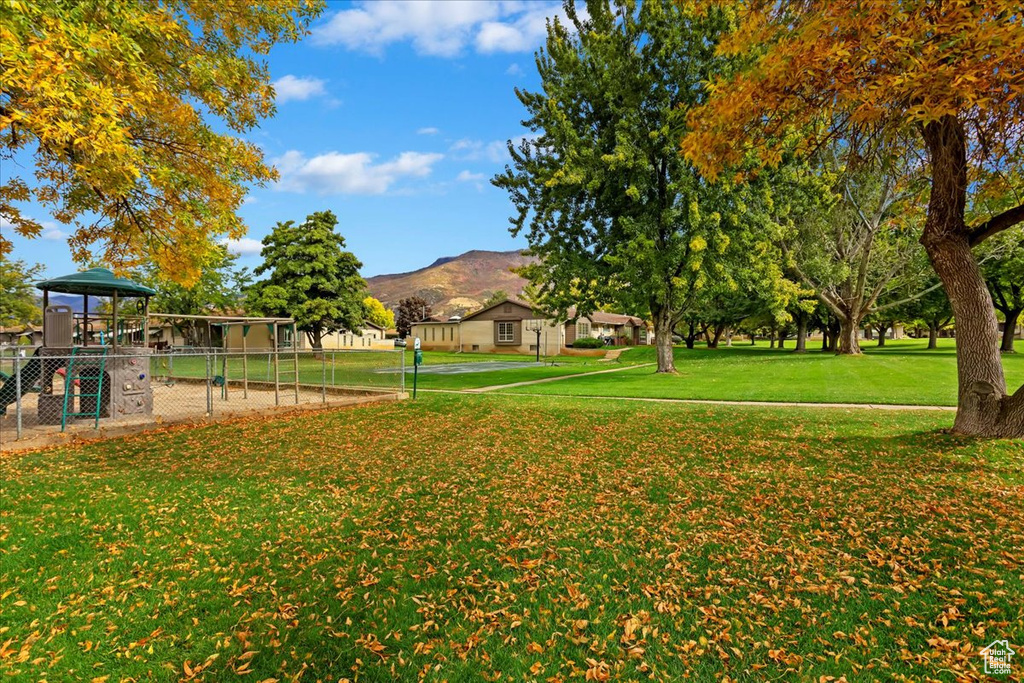 View of yard featuring a mountain view and a playground