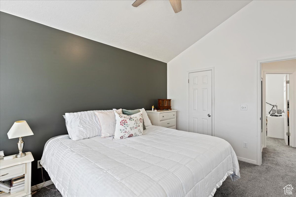 Carpeted bedroom featuring high vaulted ceiling and ceiling fan