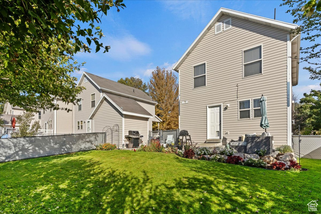 Rear view of property featuring a lawn