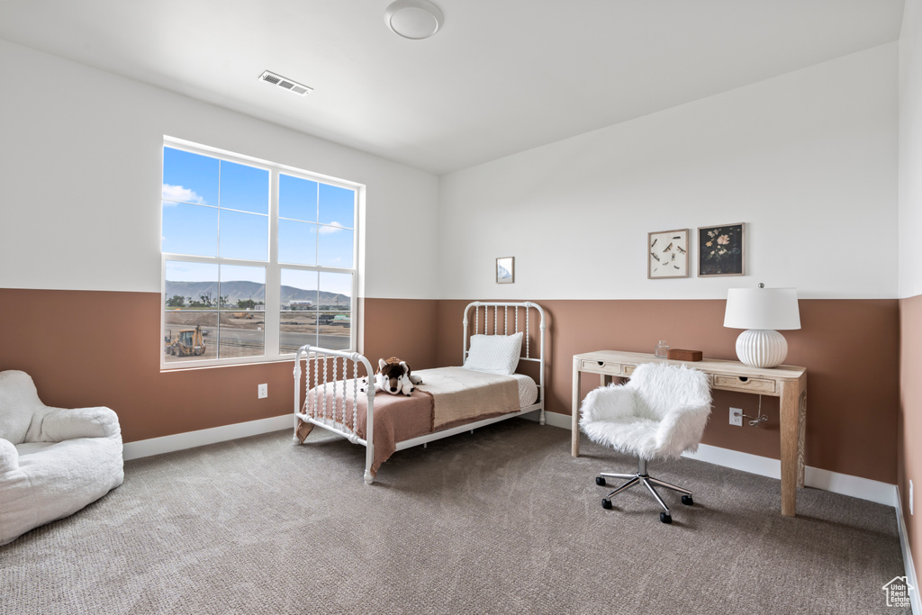 Bedroom with a mountain view and carpet