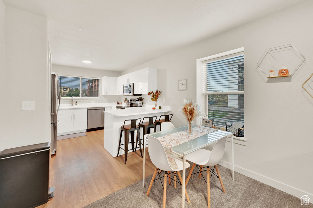 Dining space with light hardwood / wood-style floors