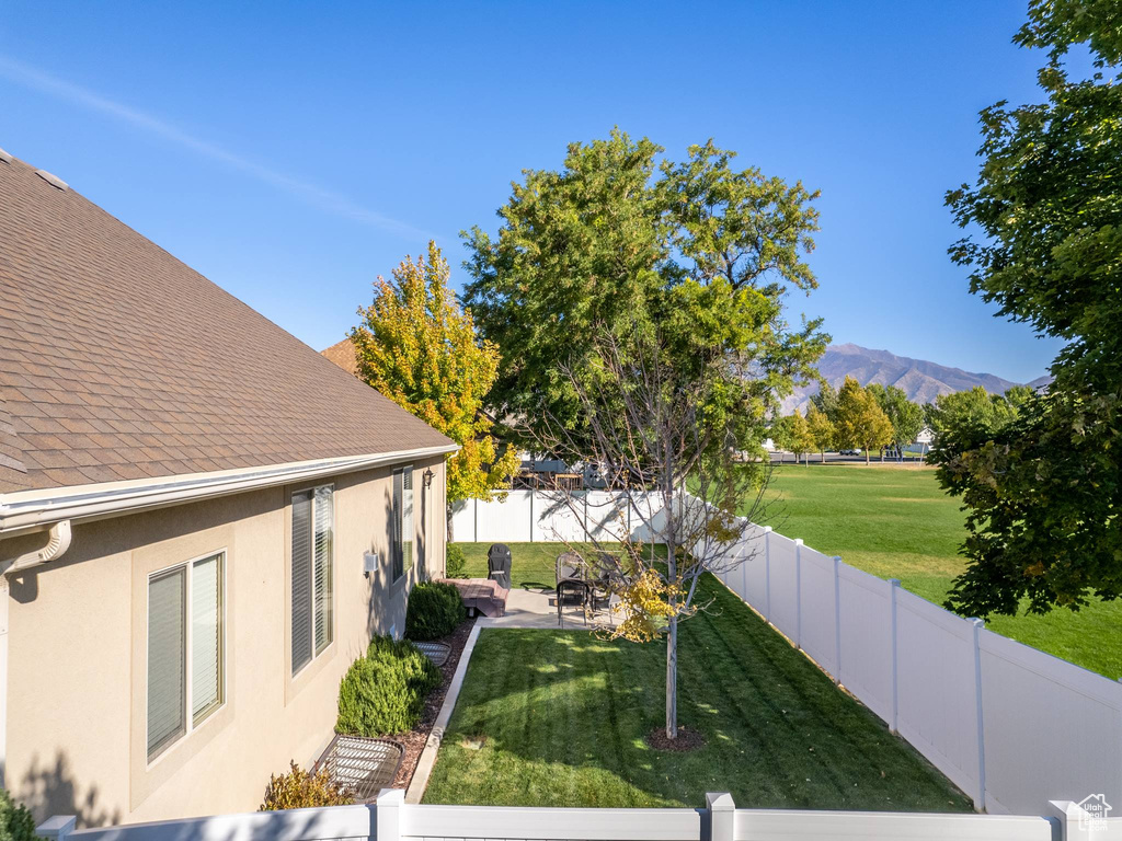 View of yard featuring a patio and a mountain view