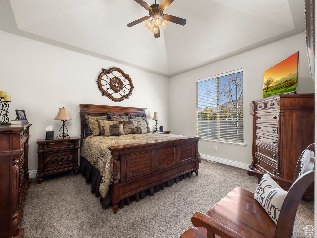 Bedroom featuring ceiling fan, carpet floors, and vaulted ceiling