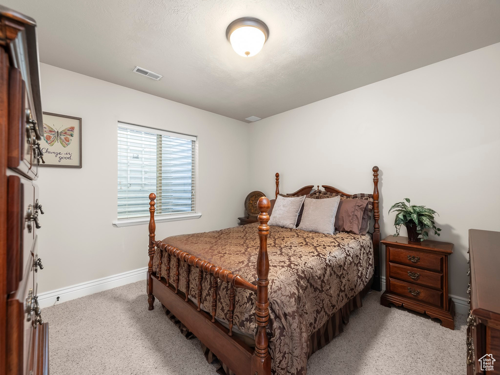 Carpeted bedroom with a textured ceiling