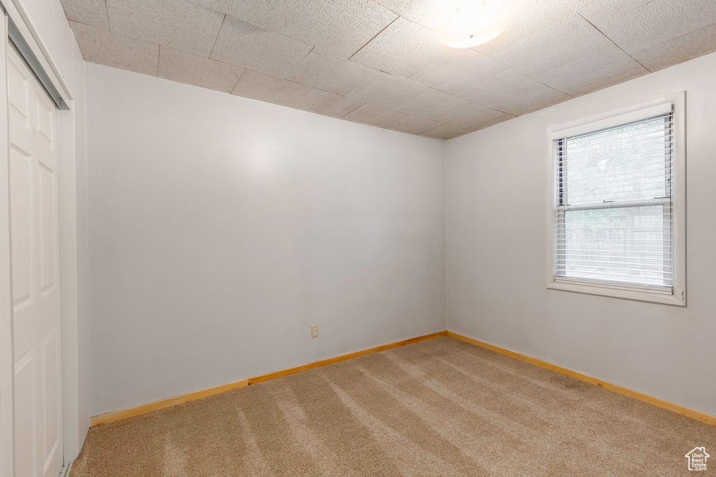 Unfurnished room with light colored carpet