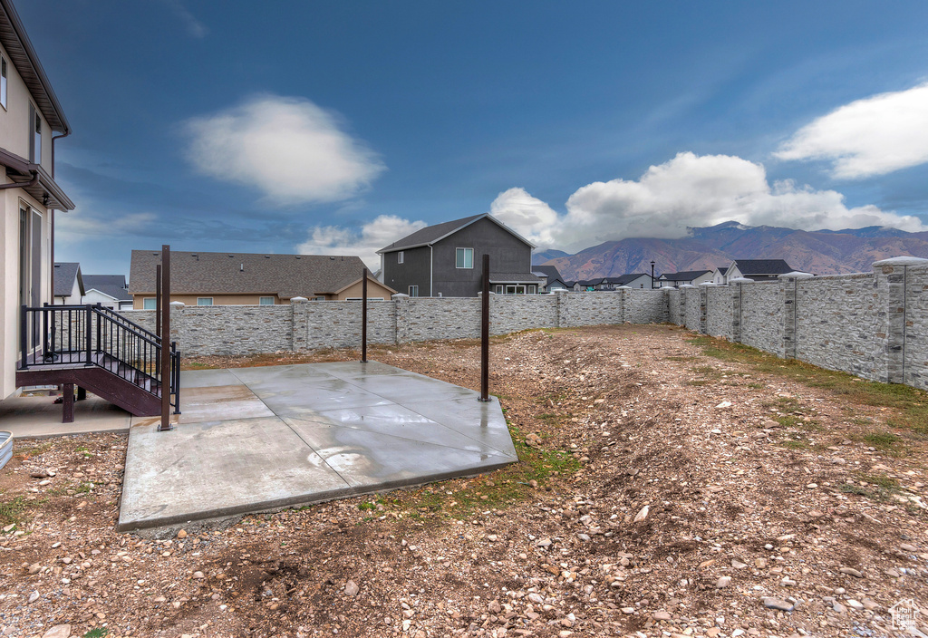 View of yard with a patio and a mountain view