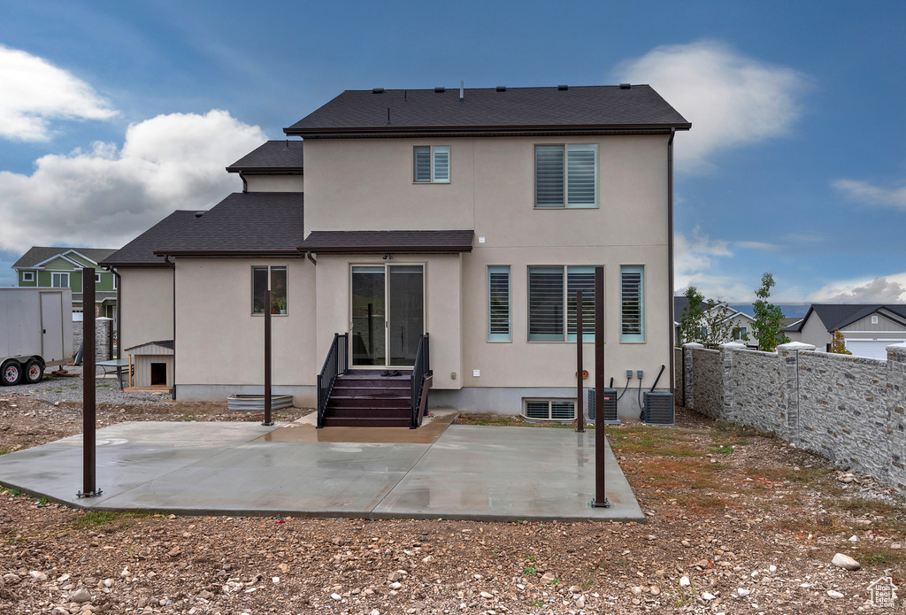 Back of house with a patio and central AC unit