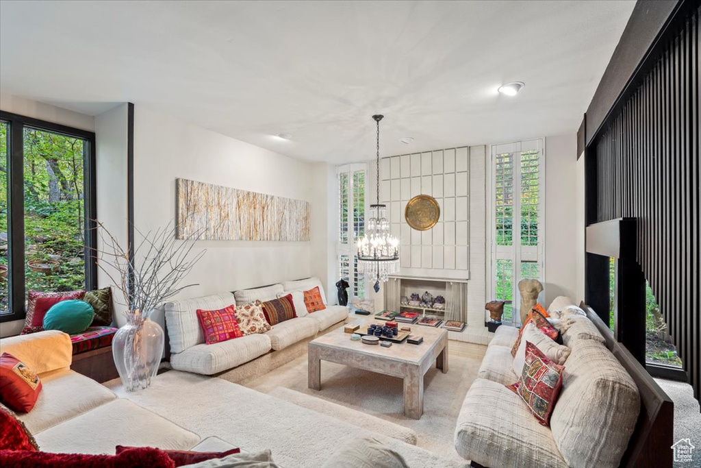 Living room featuring a notable chandelier and light colored carpet