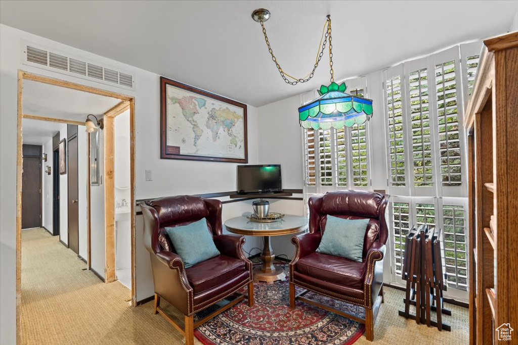 Living area featuring light colored carpet