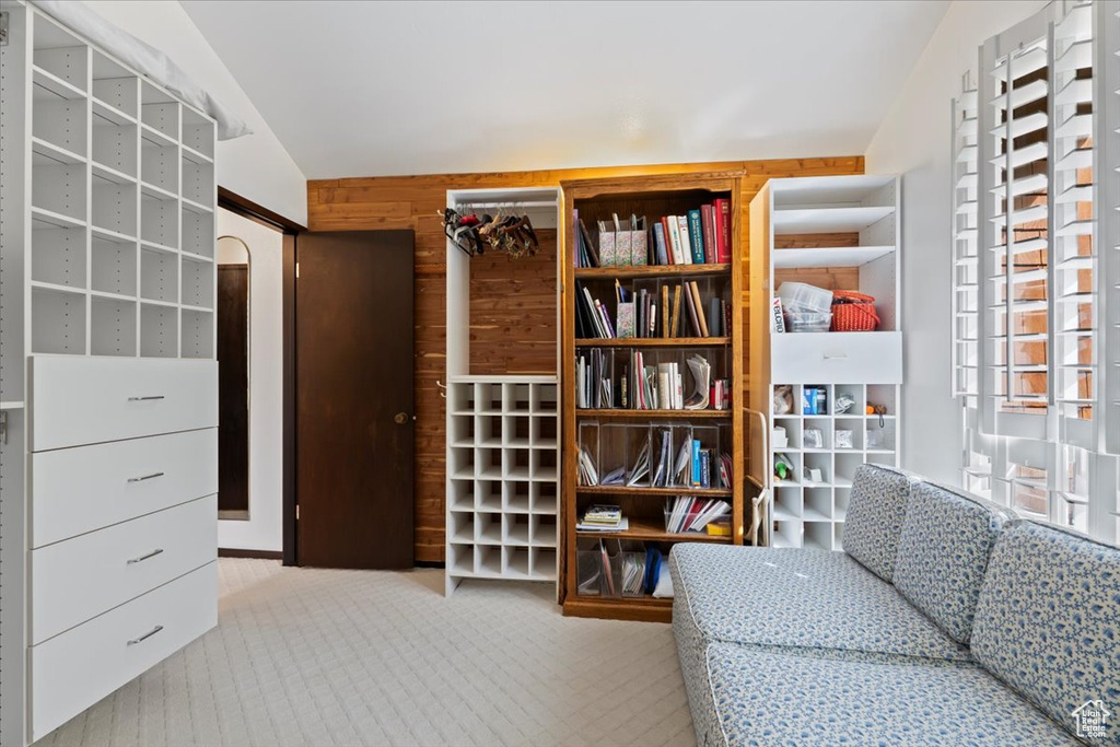 Interior space with vaulted ceiling and light colored carpet