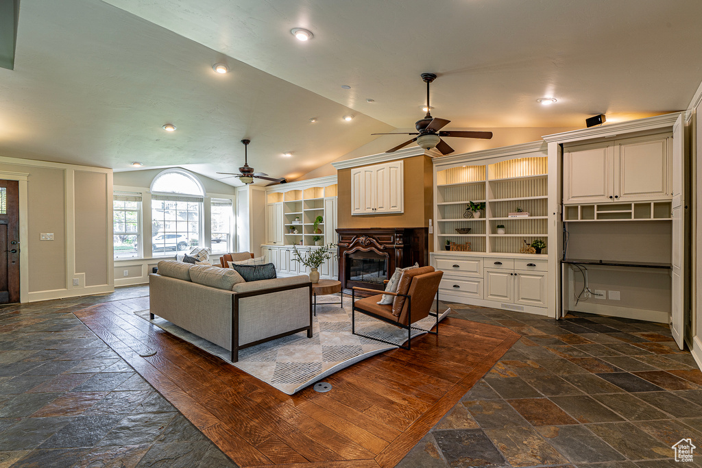 Living room with lofted ceiling and ceiling fan