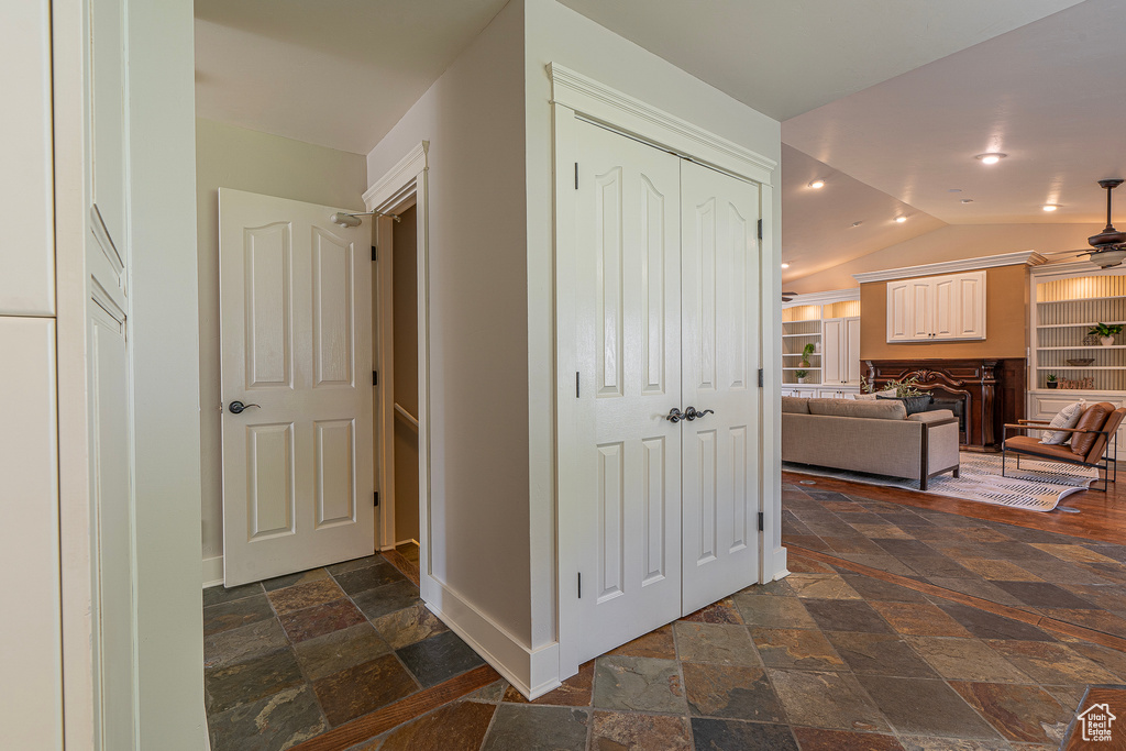 Corridor featuring vaulted ceiling and built in features