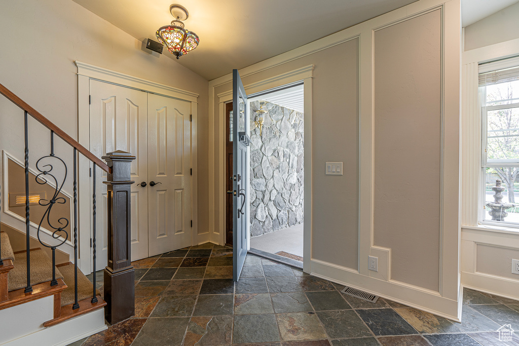 Foyer entrance with lofted ceiling