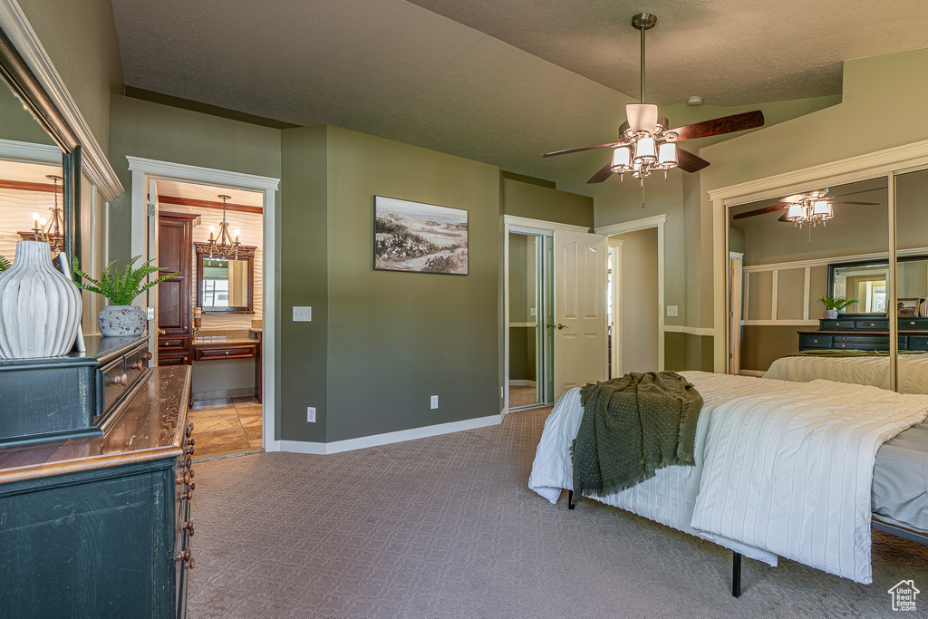 Carpeted bedroom featuring a textured ceiling and ceiling fan