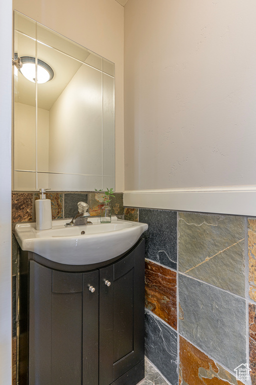 Bathroom featuring vanity and tile walls