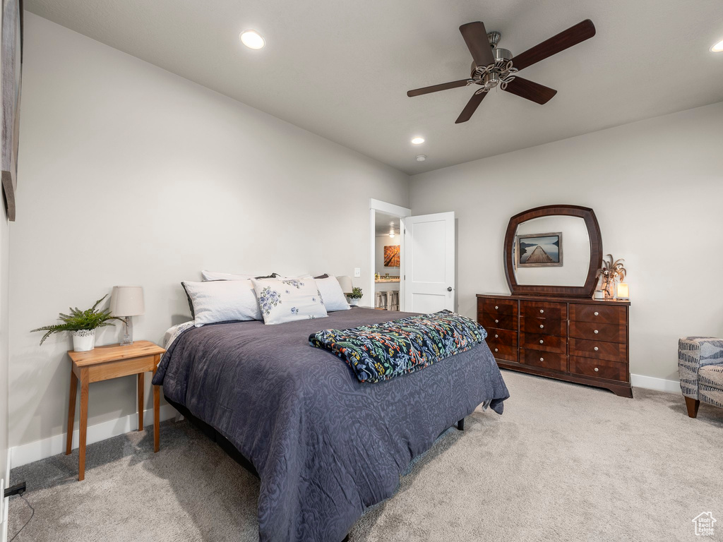 Carpeted bedroom with ceiling fan