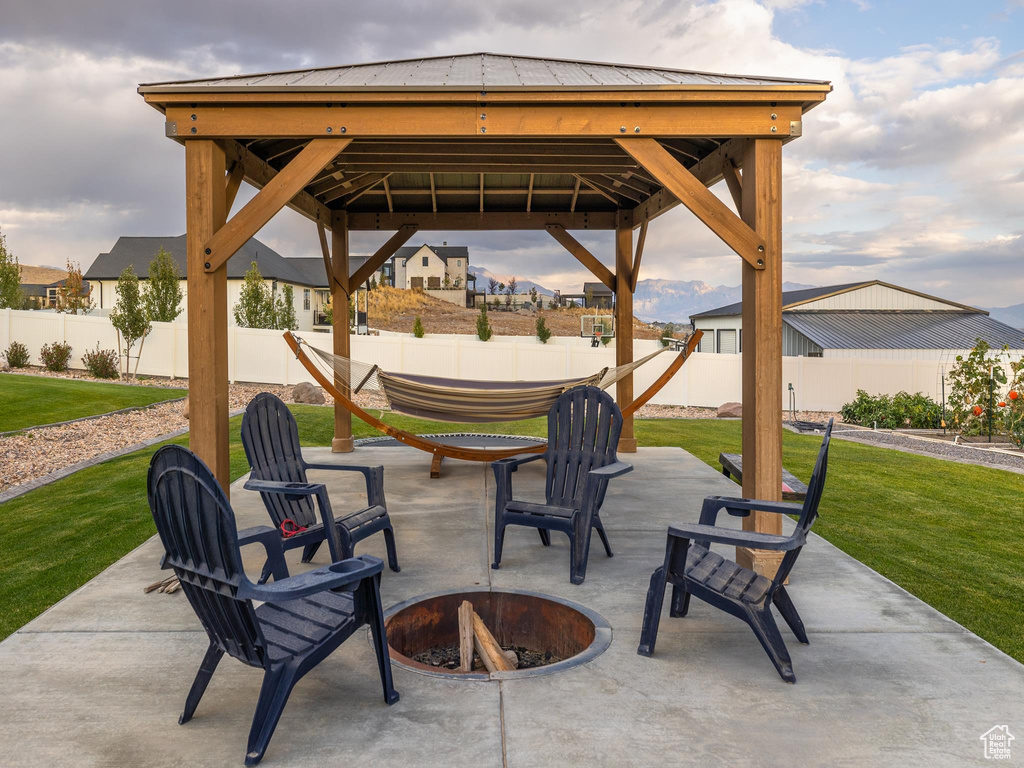 View of patio with a gazebo and a fire pit