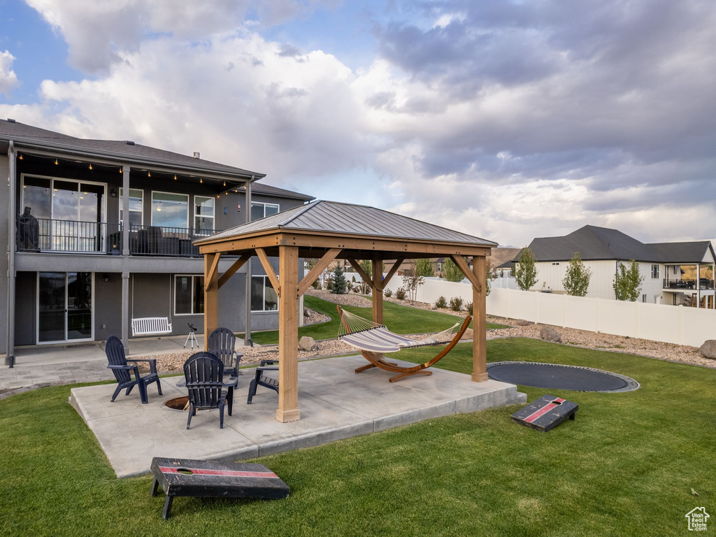 View of patio / terrace featuring a gazebo, a fire pit, and a balcony