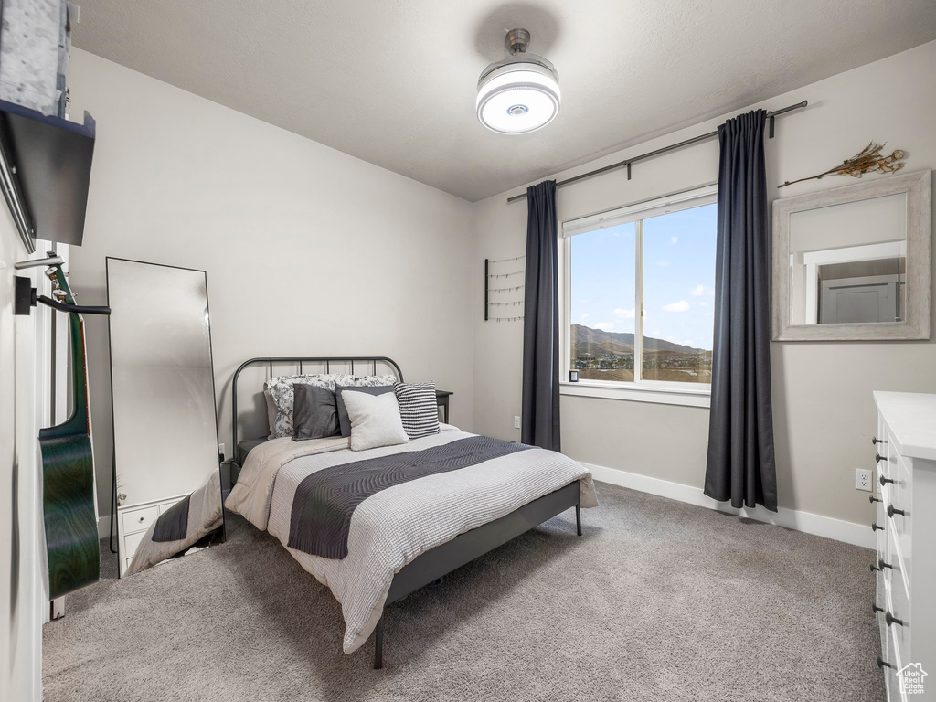 Bedroom featuring a mountain view and carpet floors