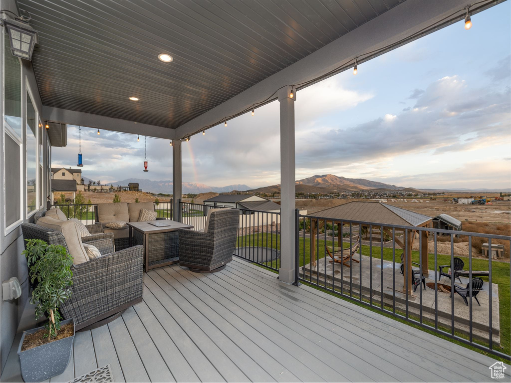 Wooden terrace featuring a mountain view and an outdoor hangout area