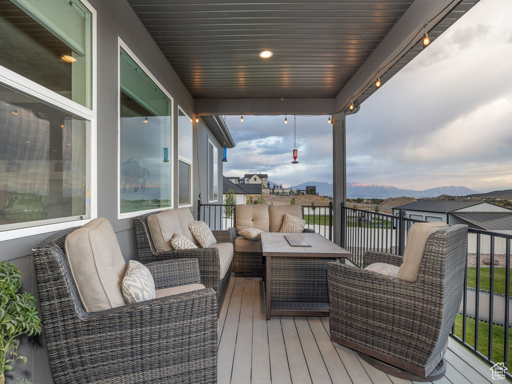 Wooden deck featuring a mountain view and an outdoor hangout area