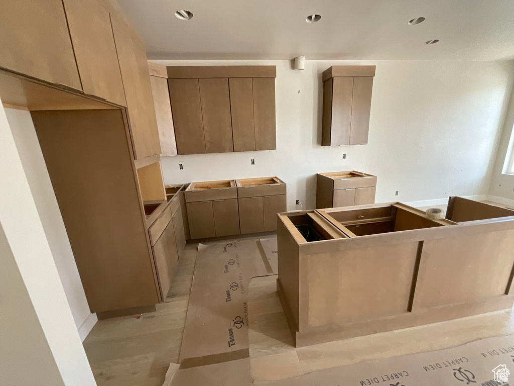 Kitchen featuring light brown cabinetry and a center island