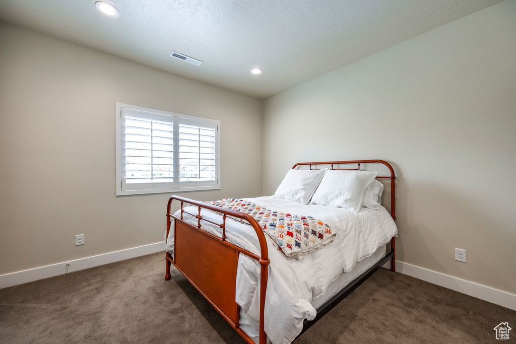 Carpeted bedroom featuring a textured ceiling