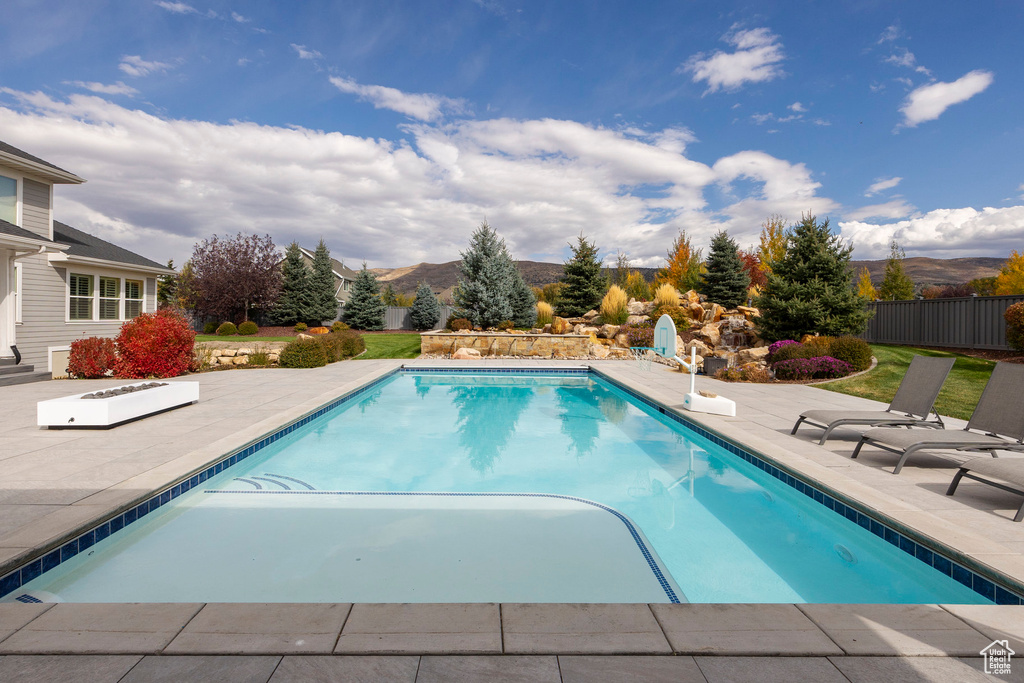 View of swimming pool featuring a mountain view and a patio area