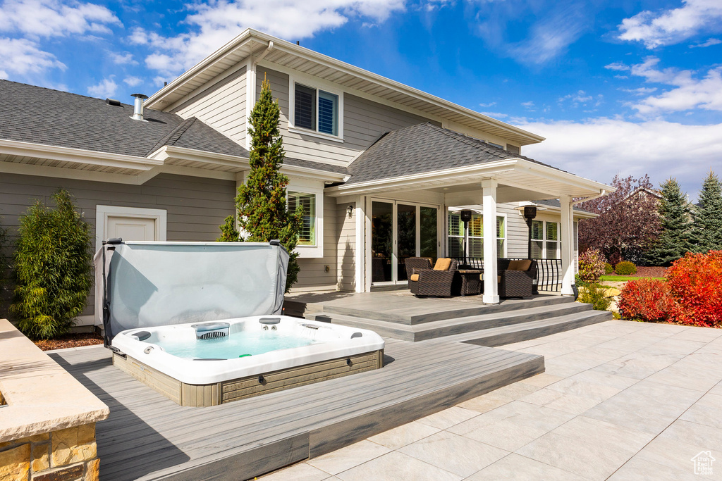 Wooden deck featuring a covered hot tub