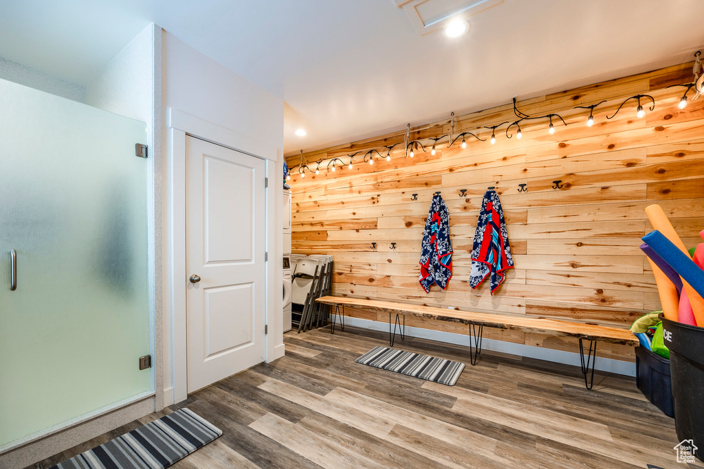 Mudroom featuring wood-type flooring and wooden walls