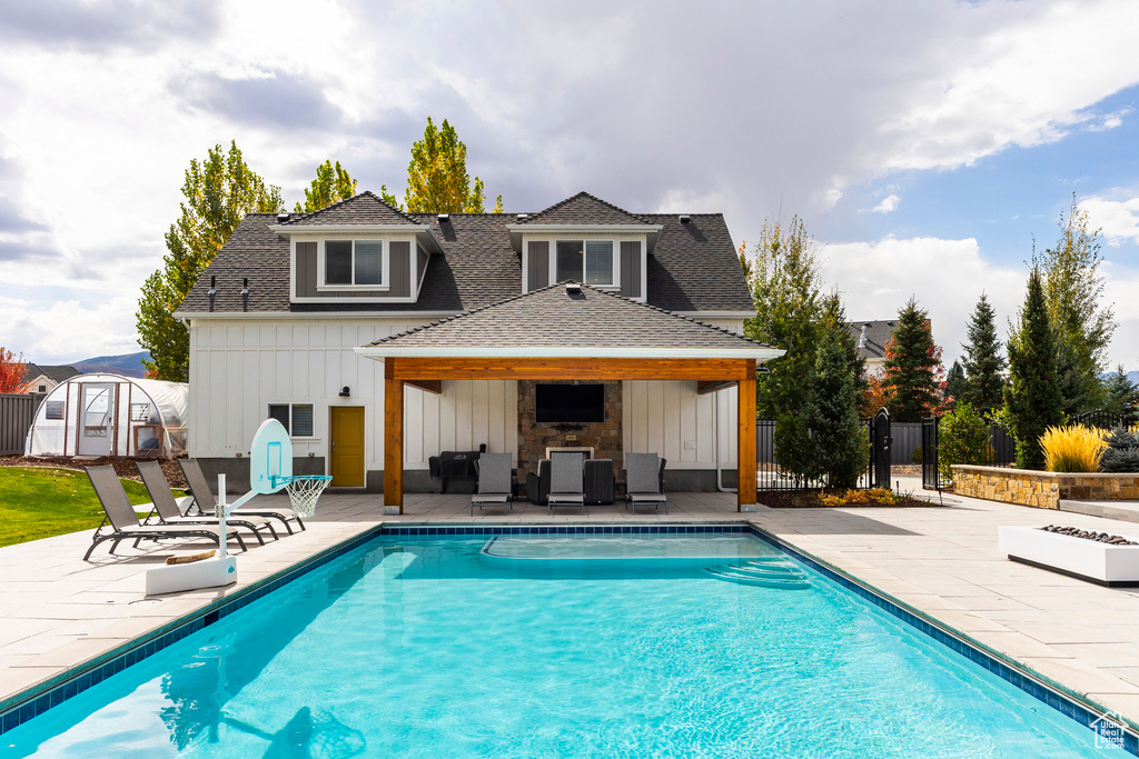 Back of house featuring a shed and a patio area