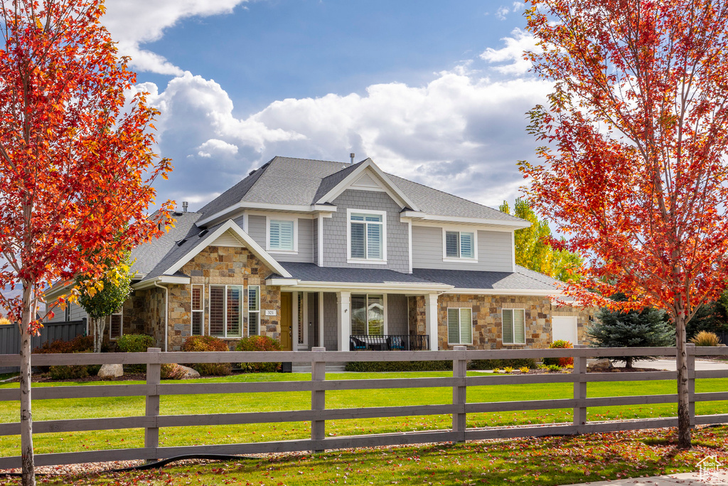 View of front facade featuring a porch and a front yard