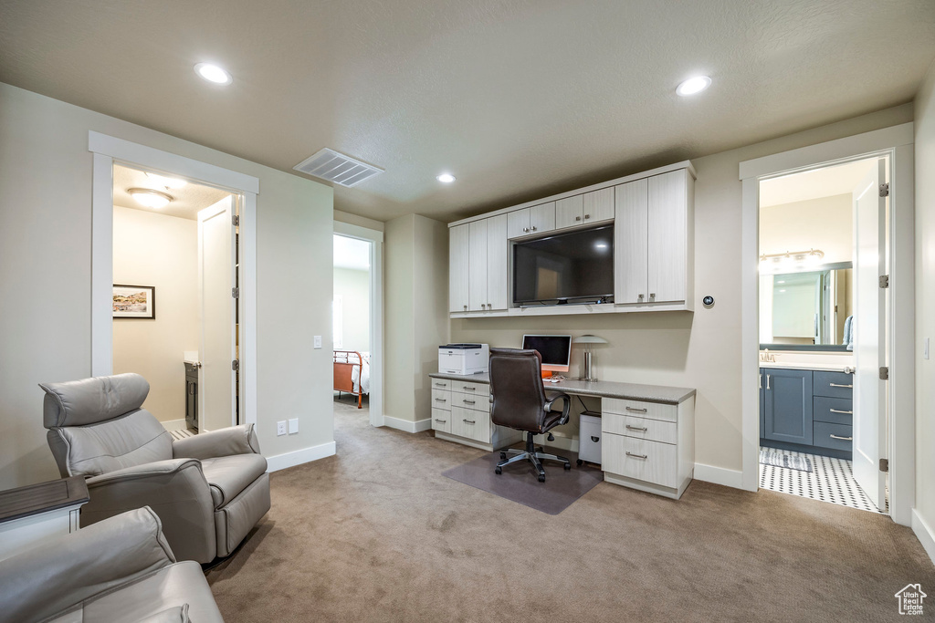 Home office with light carpet