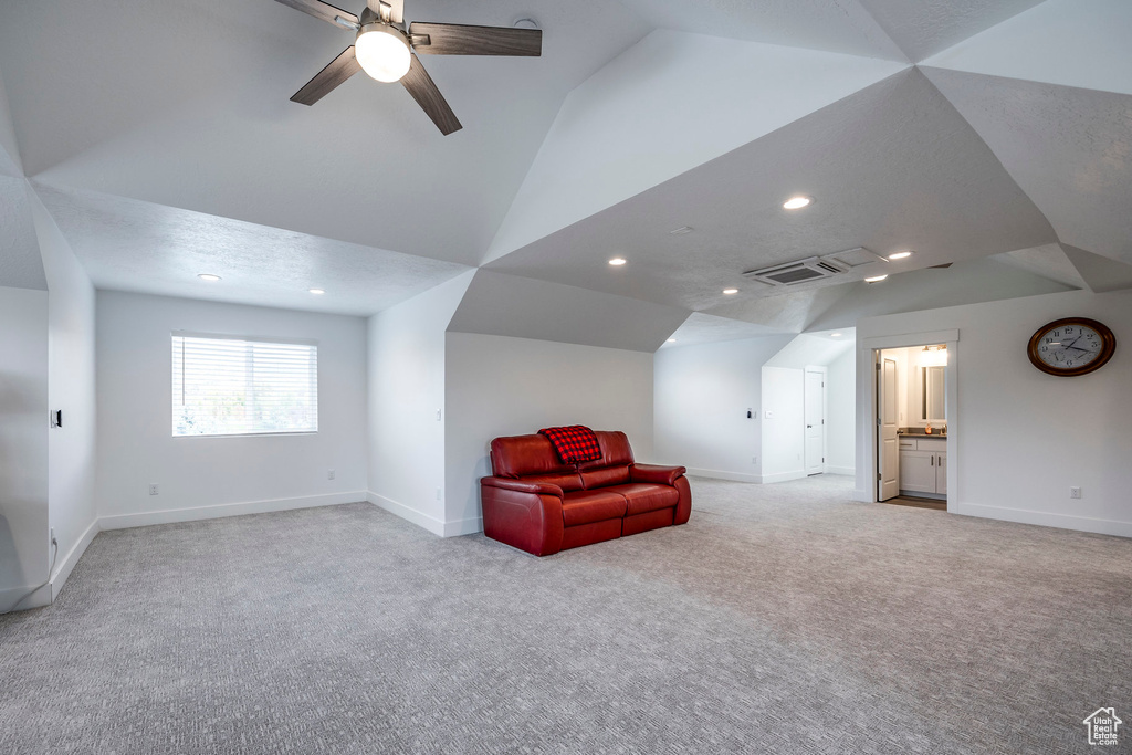 Unfurnished room with ceiling fan, lofted ceiling, and light colored carpet