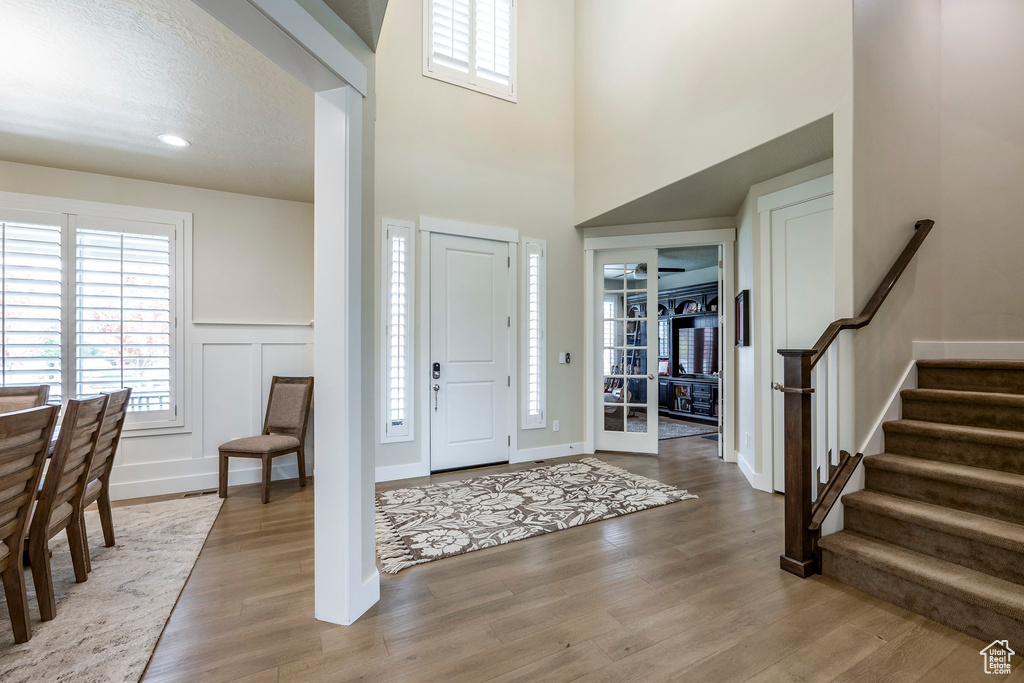 Entryway with hardwood / wood-style flooring and a textured ceiling