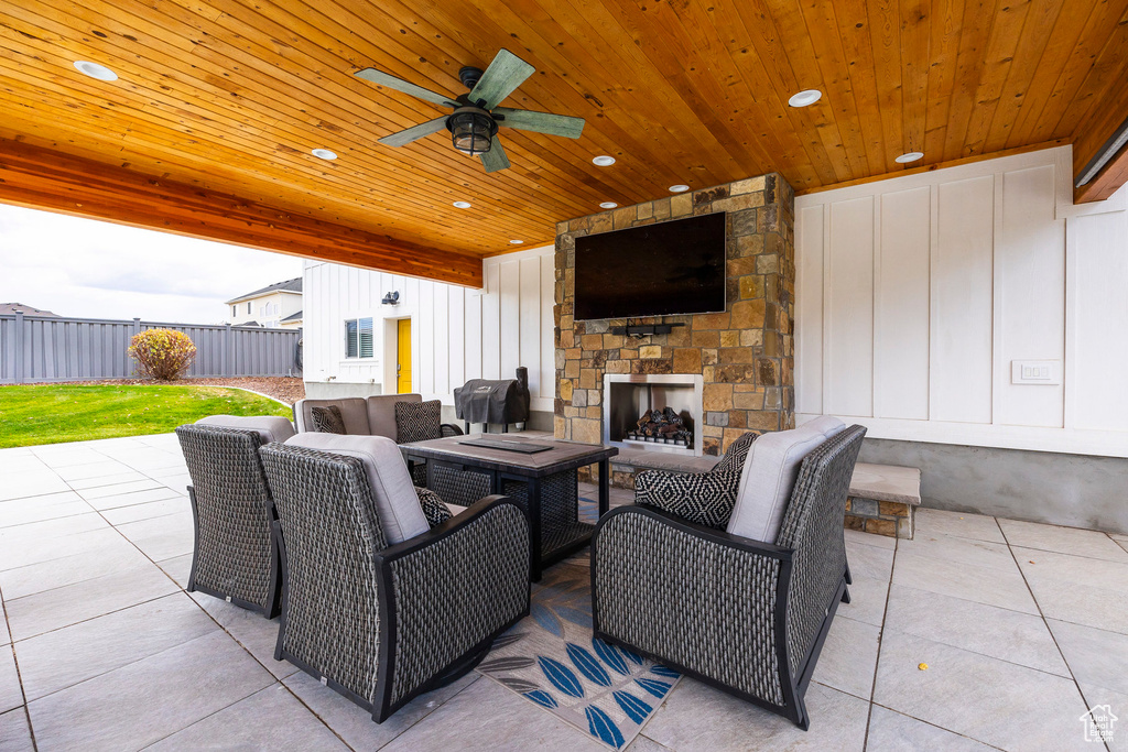 View of patio / terrace featuring an outdoor living space with a fireplace and ceiling fan