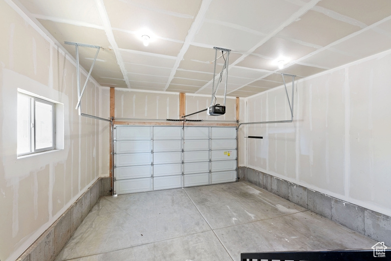 Garage featuring a garage door opener