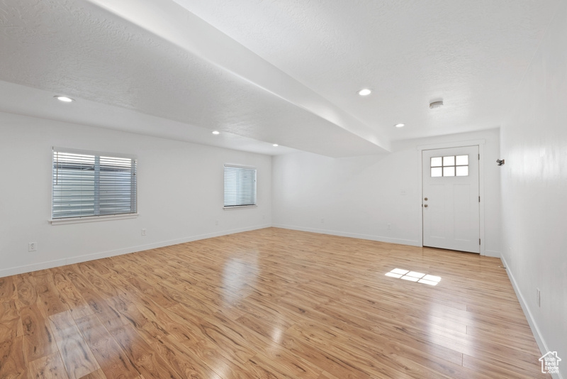 Interior space featuring light hardwood / wood-style flooring and a textured ceiling