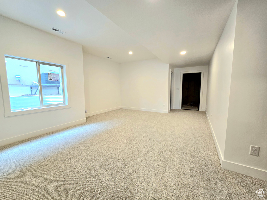 Empty room featuring light colored carpet