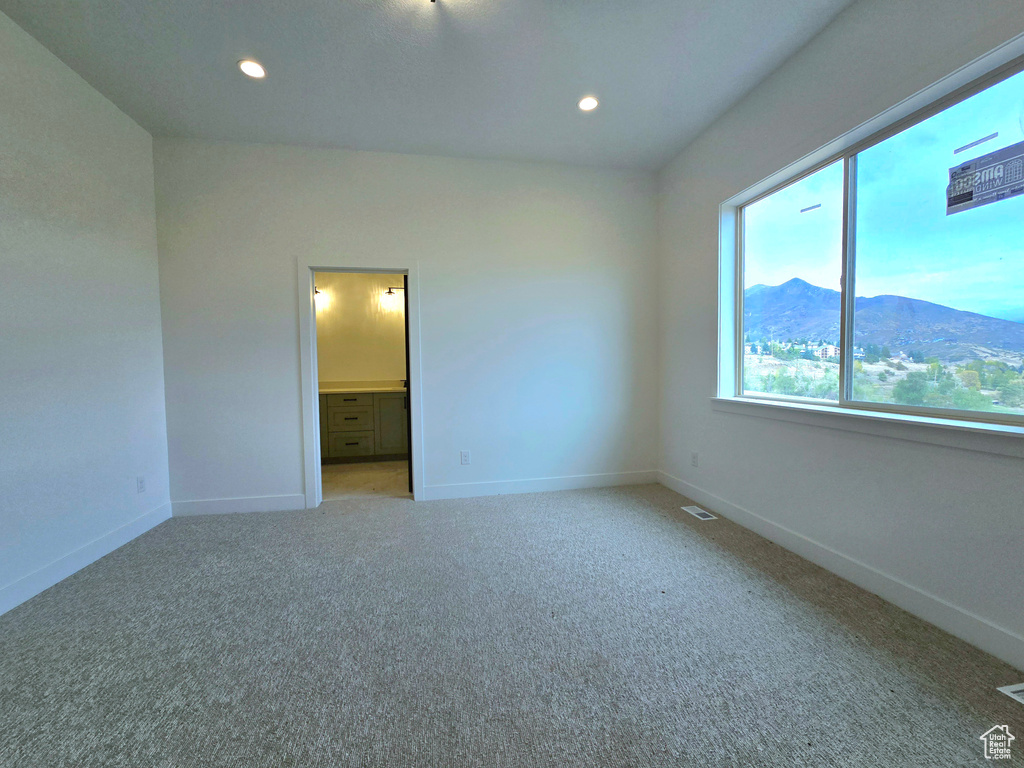 Carpeted empty room with a mountain view