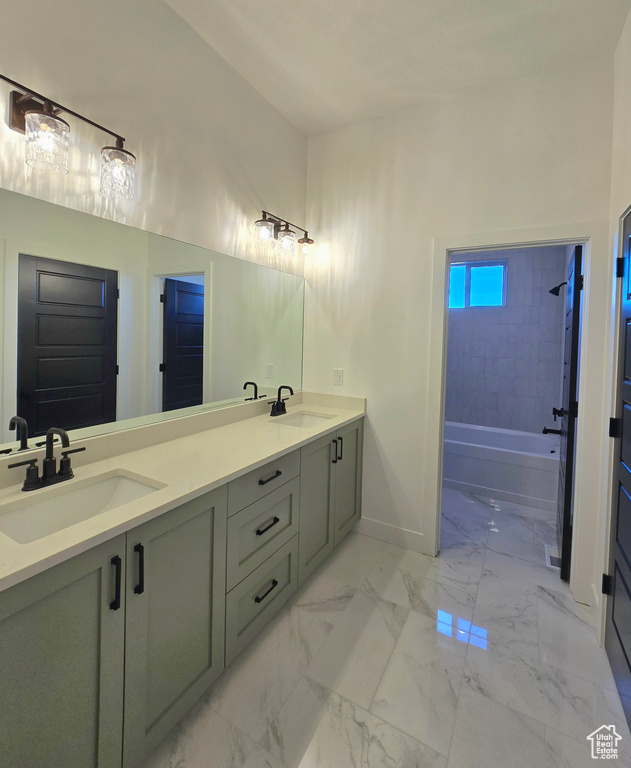 Bathroom with vanity and tiled shower / bath