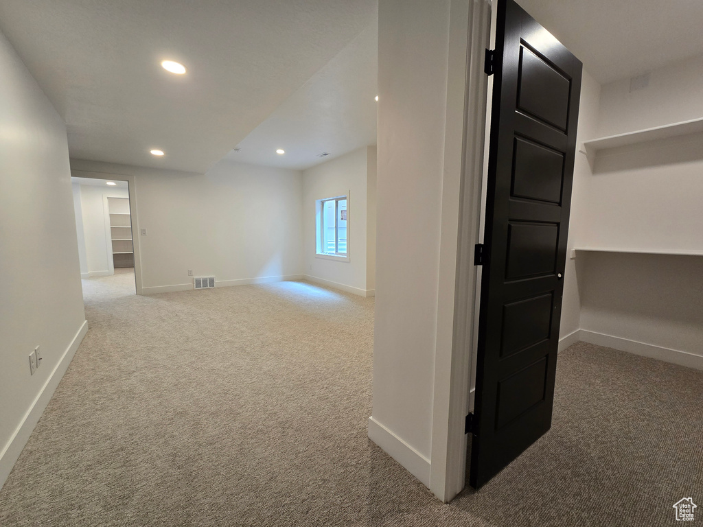 Hall featuring carpet flooring