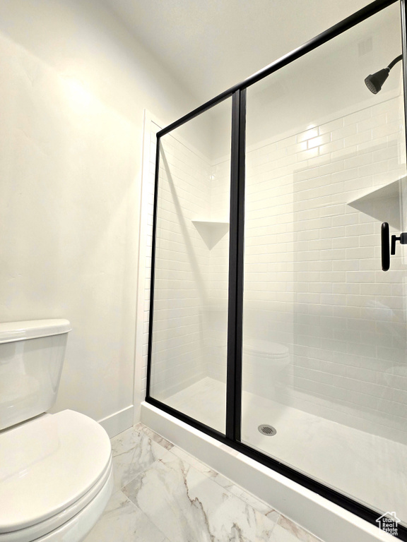 Bathroom featuring toilet and walk in shower
