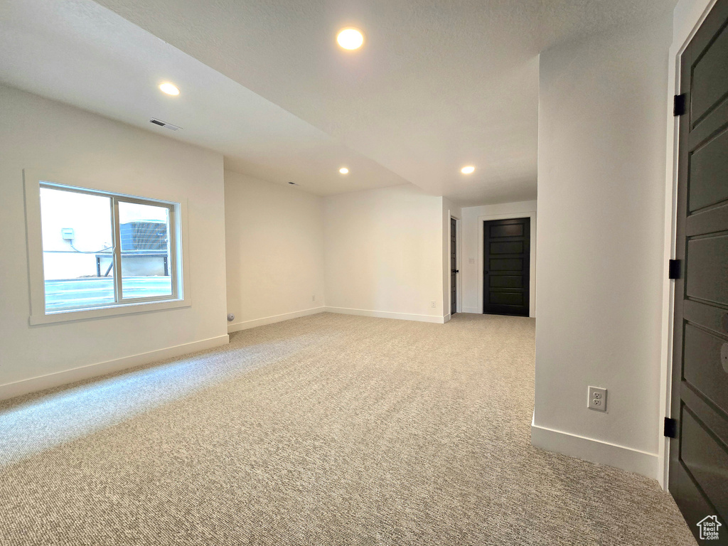 Unfurnished room with light colored carpet