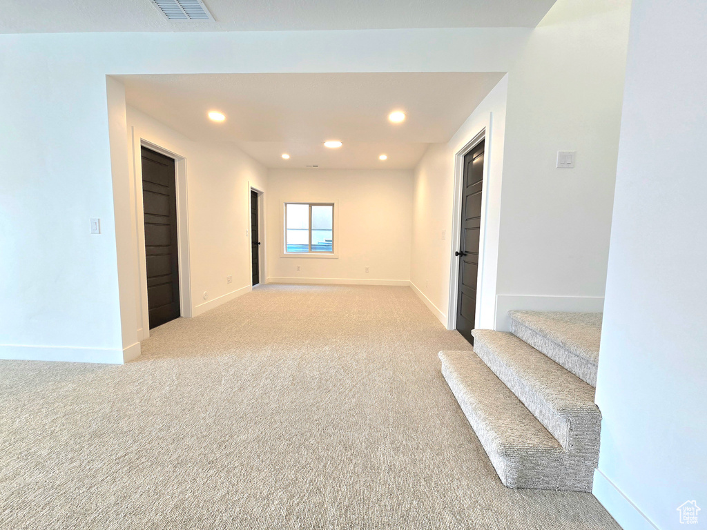Spare room with light colored carpet
