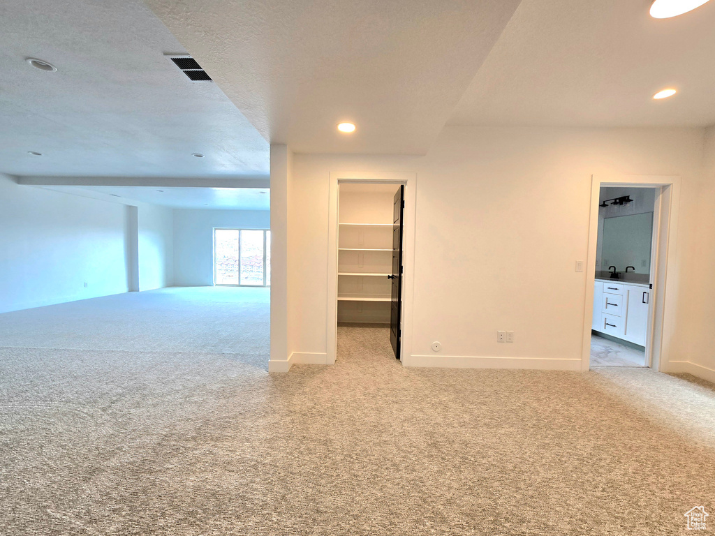 Carpeted empty room with a textured ceiling