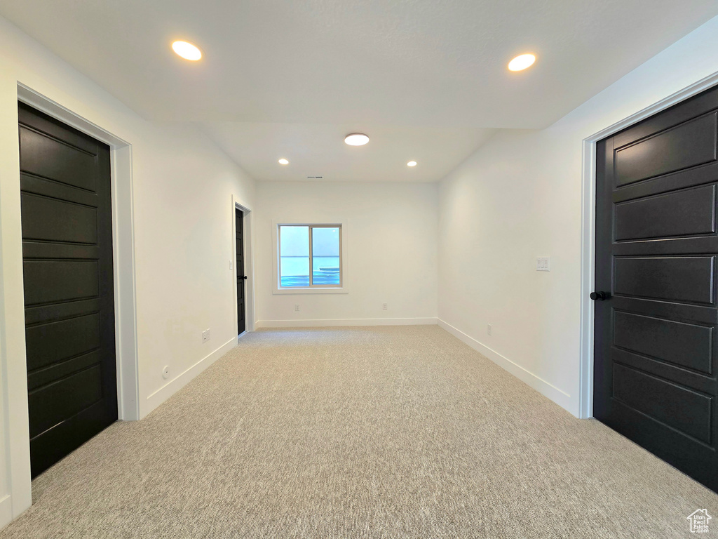 Empty room featuring light colored carpet