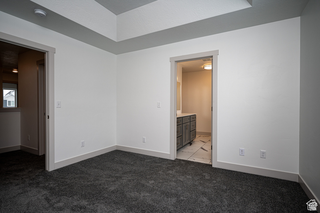 Carpeted empty room with a textured ceiling